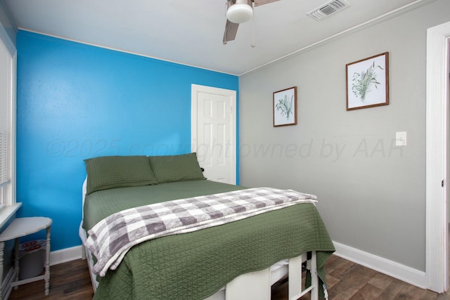 bedroom featuring dark wood finished floors, baseboards, ceiling fan, and visible vents