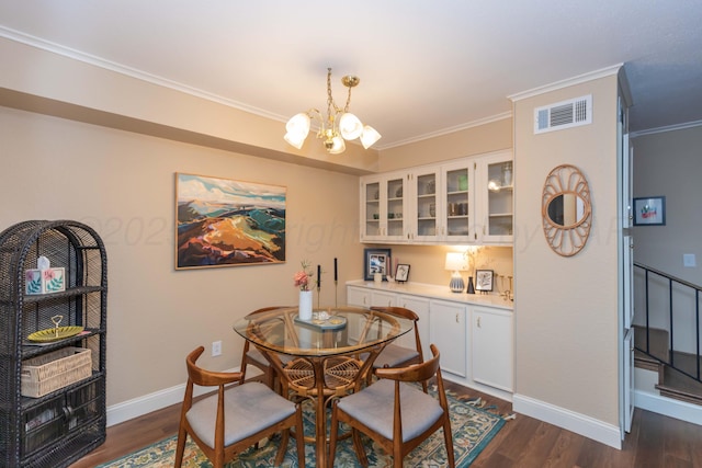 1506 S Alabama St, Amarillo, TX 79102 - dining area with a chandelier, baseboards, dark wood-type flooring, and crown molding