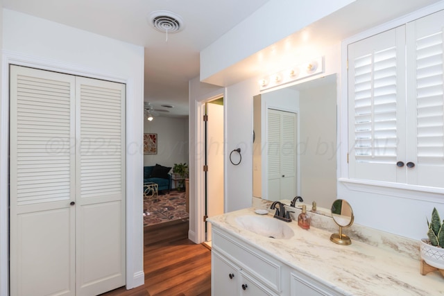 1506 S Alabama St, Amarillo, TX 79102 - bathroom with a closet, vanity, wood finished floors, and ceiling fan