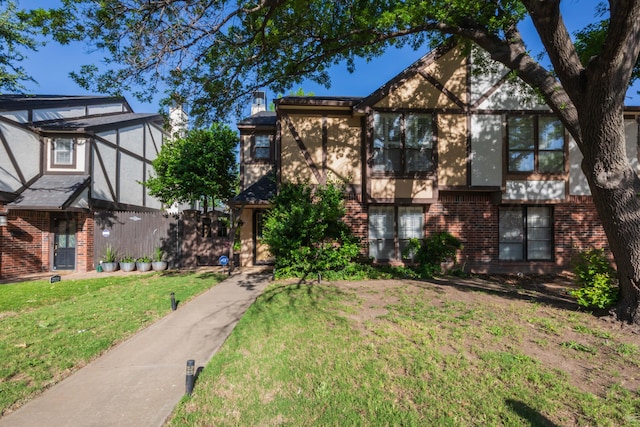 1506 S Alabama St, Amarillo, TX 79102 - english style home featuring brick siding, a front yard, and stucco siding