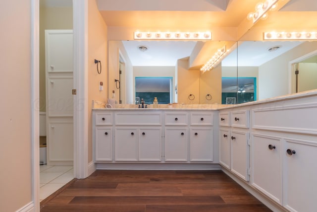 1506 S Alabama St, Amarillo, TX 79102 - bathroom with double vanity, wood finished floors, and a ceiling fan