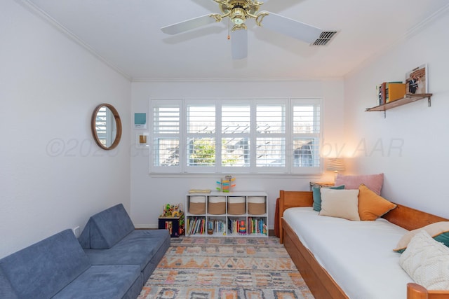 bedroom with ornamental molding, visible vents, and a ceiling fan