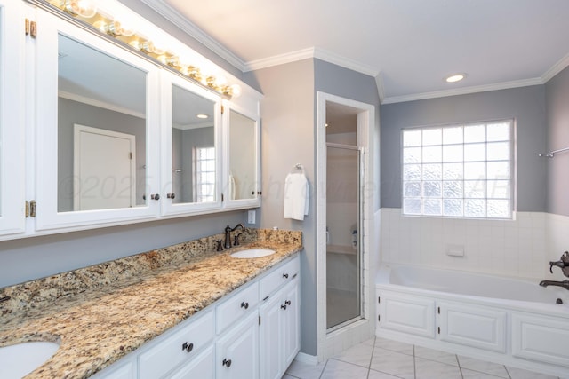 full bathroom with a shower stall, crown molding, double vanity, and a sink