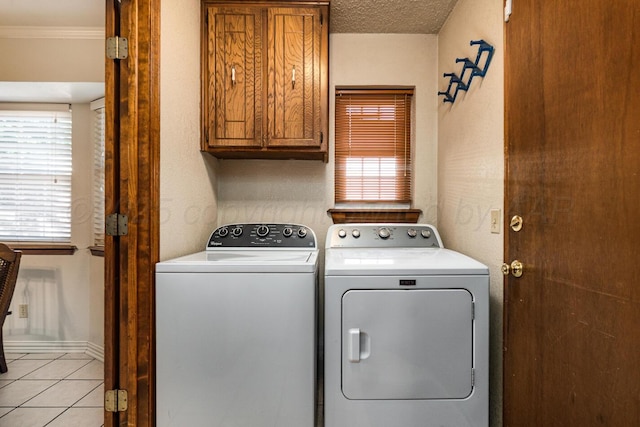 7503 Elmhurst Dr, Amarillo, TX 79121 - washroom featuring cabinet space, washing machine and clothes dryer, light tile patterned flooring, and crown molding