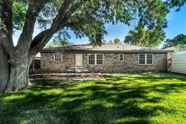 7503 Elmhurst Dr, Amarillo, TX 79121 - back of house with brick siding, a patio area, and a yard