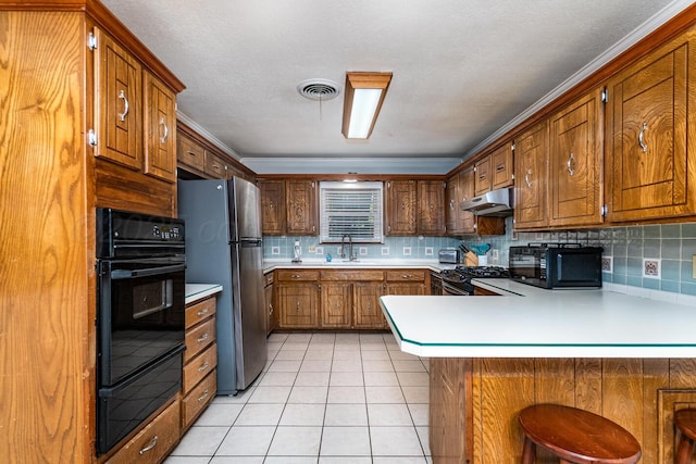 7503 Elmhurst Dr, Amarillo, TX 79121 - kitchen featuring black appliances, under cabinet range hood, a warming drawer, light countertops, and a peninsula