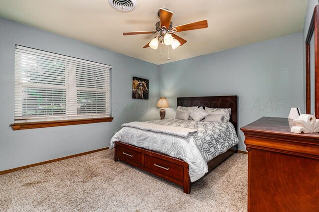 7503 Elmhurst Dr, Amarillo, TX 79121 - bedroom with light colored carpet and ceiling fan