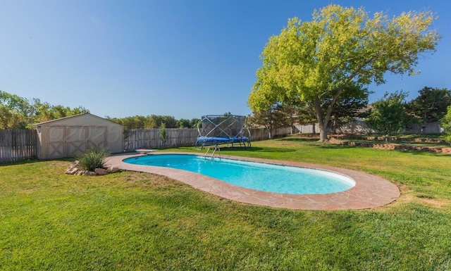 view of pool featuring a trampoline, a shed, an outbuilding, and a diving board