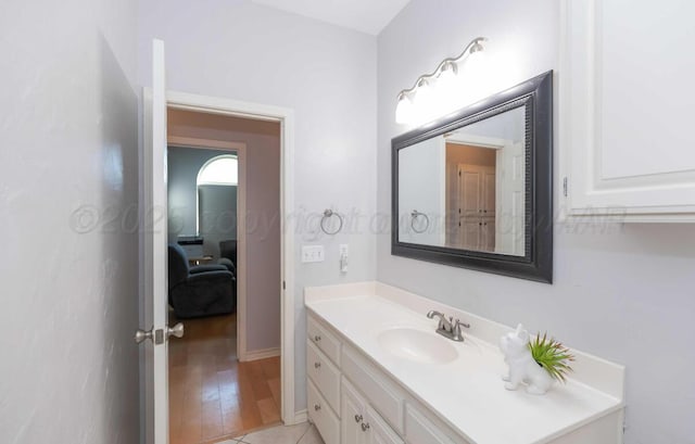 bathroom with vanity and wood finished floors