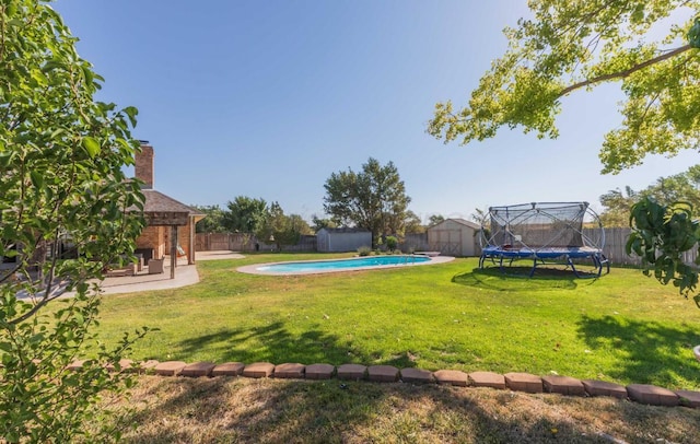 view of yard featuring a storage shed, a trampoline, an outdoor structure, a patio, and a gazebo