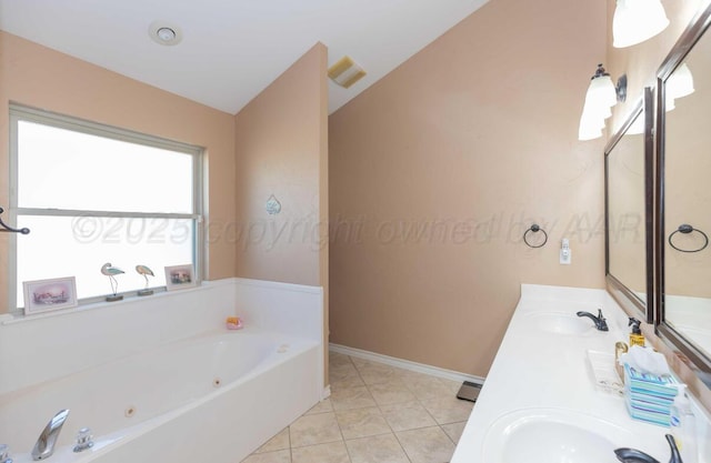 full bath featuring a tub with jets, double vanity, baseboards, and tile patterned flooring