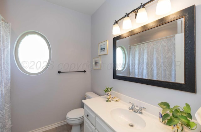 bathroom featuring toilet, vanity, tile patterned floors, and a shower with shower curtain