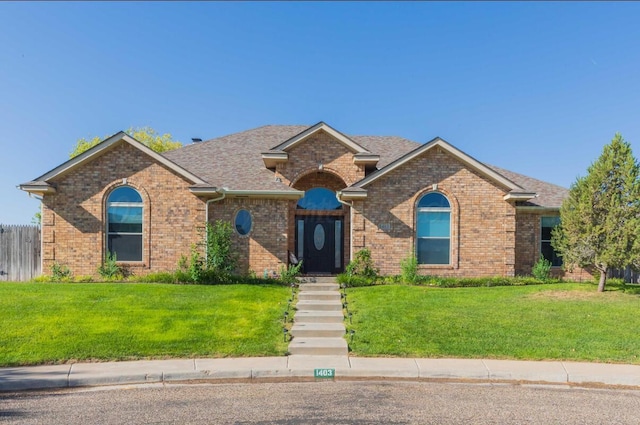 view of front of home with brick siding and a shingled roof