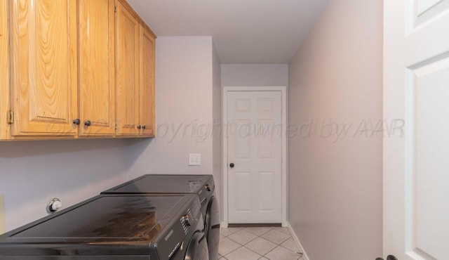 washroom with washing machine and clothes dryer, cabinet space, light tile patterned flooring, and baseboards