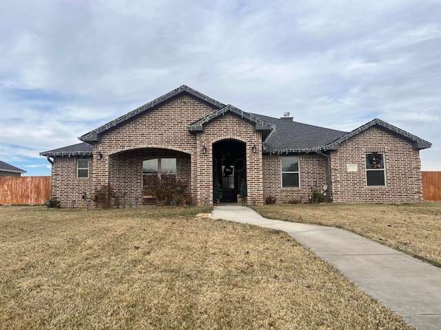 1712 NE 6th St, Dumas, TX 79020 - french provincial home with brick siding and a shingled roof