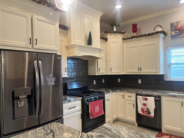 1712 NE 6th St, Dumas, TX 79020 - kitchen featuring stainless steel fridge with ice dispenser, black range with gas cooktop, dishwashing machine, dark stone countertops, and white cabinets