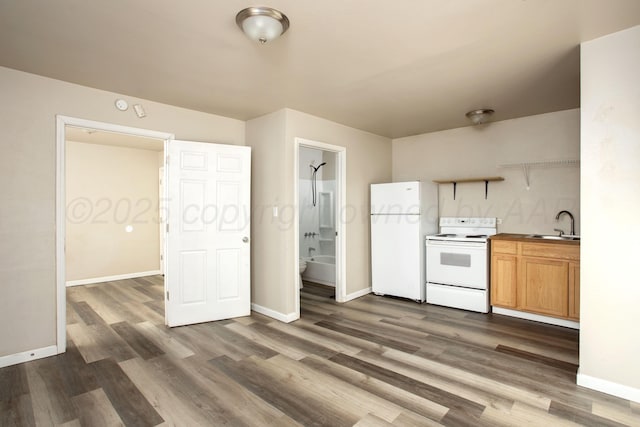 kitchen featuring sink, dark hardwood / wood-style flooring, and white appliances