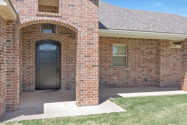 19550 Saddlehorn Rd, Amarillo, TX 79119 - view of exterior entry featuring brick siding and a shingled roof