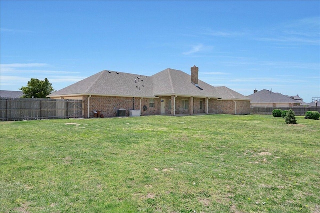19550 Saddlehorn Rd, Amarillo, TX 79119 - rear view of house with brick siding, a chimney, central air condition unit, and a shingled roof