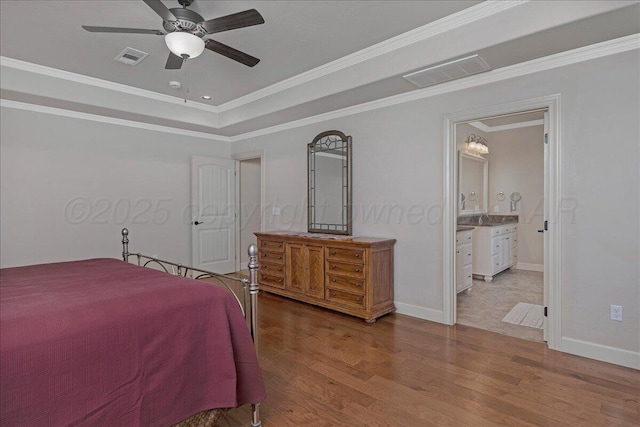 19550 Saddlehorn Rd, Amarillo, TX 79119 - bedroom featuring wood finished floors, ornamental molding, baseboards, and a raised ceiling