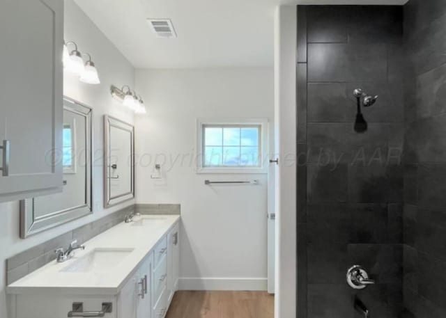 1603 Fox Terrier Ave, Amarillo, TX 79018 - full bathroom with wood finished floors, double vanity, and a tile shower