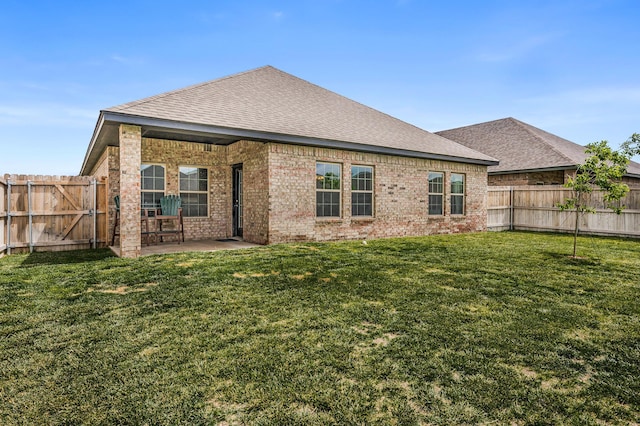 9913 Hartnett Ct, Amarillo, TX 79119 - back of property with brick siding, a shingled roof, and a patio