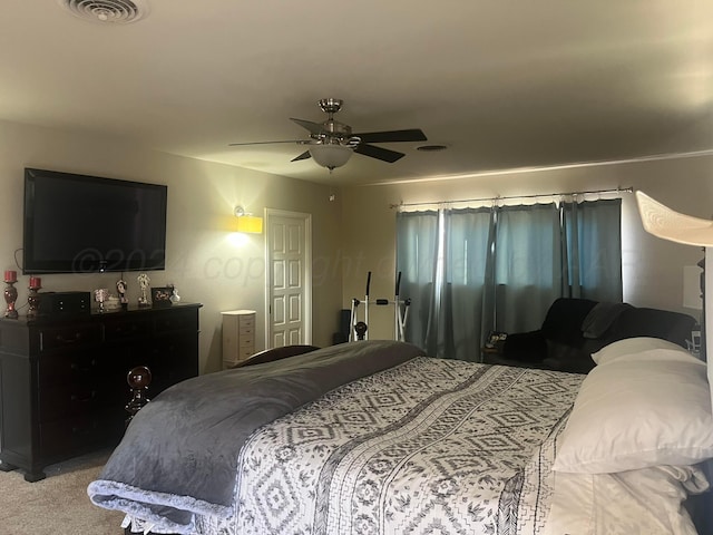carpeted bedroom with a ceiling fan and visible vents