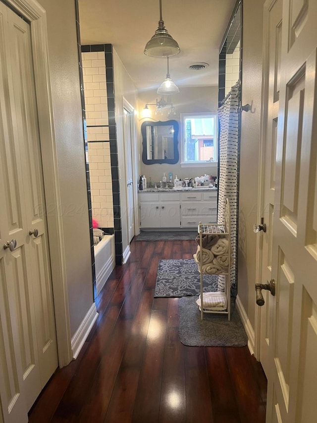 full bathroom with vanity, hardwood / wood-style flooring, and visible vents
