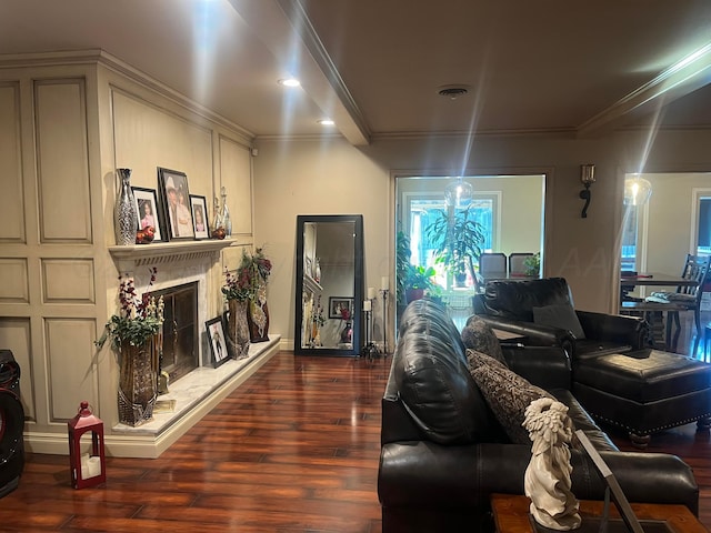 living room featuring a fireplace, crown molding, dark wood-type flooring, and visible vents