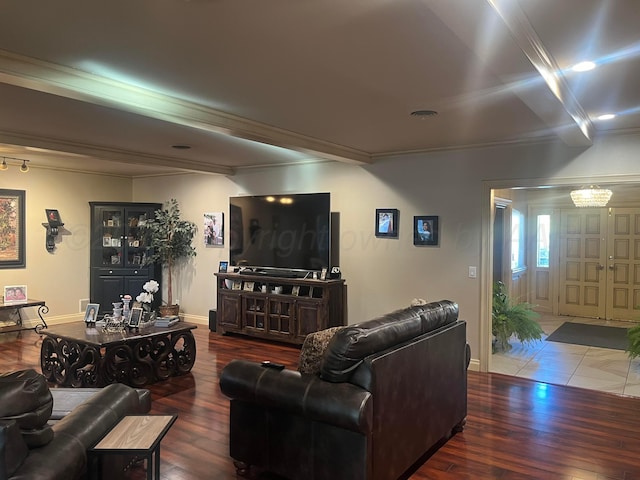 living room featuring ornamental molding, baseboards, and wood finished floors