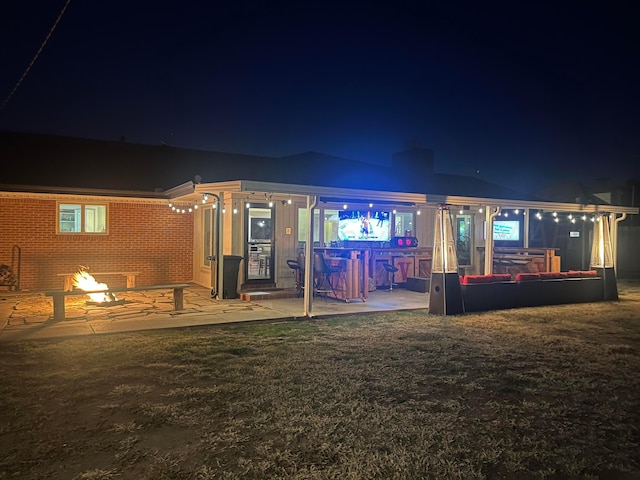 back of house at night with brick siding