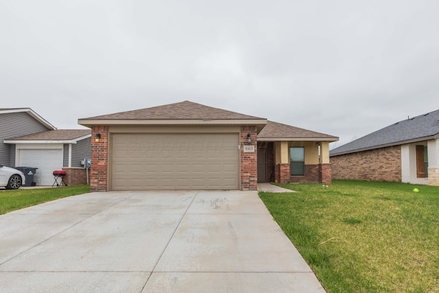 view of front of home with a front lawn, roof with shingles, brick siding, concrete driveway, and an attached garage