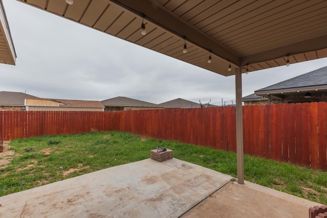 view of yard with a fenced backyard and a patio