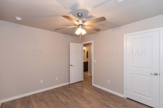 unfurnished bedroom featuring baseboards, ceiling fan, and wood finished floors