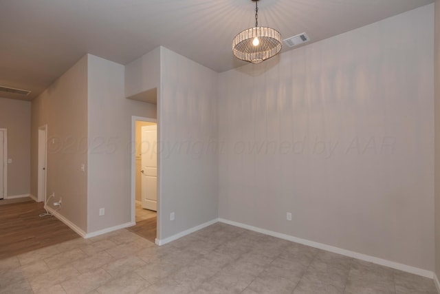 empty room with visible vents and baseboards