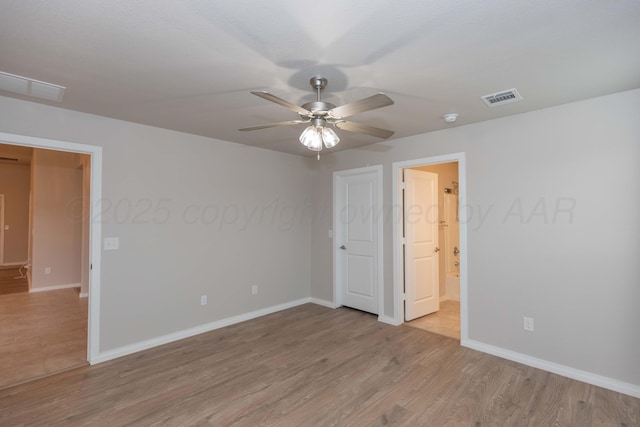 unfurnished bedroom featuring baseboards, visible vents, and light wood-style floors