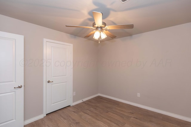 unfurnished room with baseboards, ceiling fan, and wood finished floors
