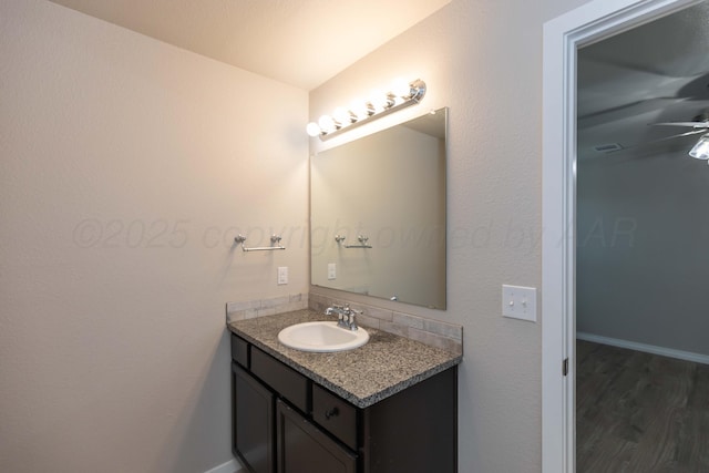 bathroom featuring vanity, a ceiling fan, and wood finished floors