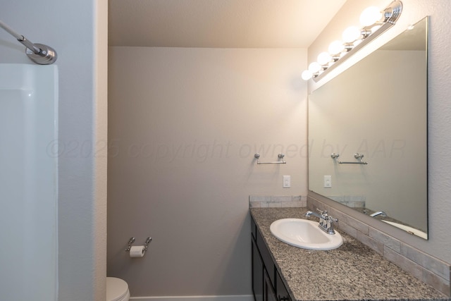 bathroom featuring vanity and toilet