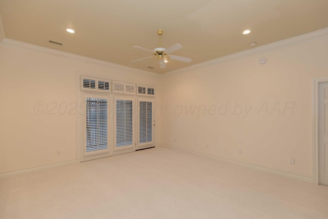 spare room with crown molding and carpet