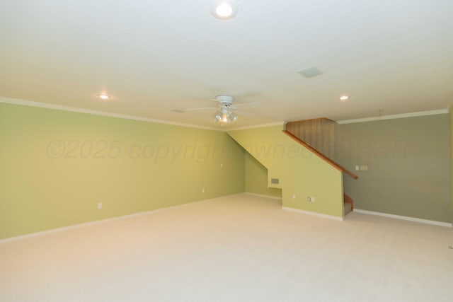 interior space featuring ornamental molding, ceiling fan, and carpet flooring