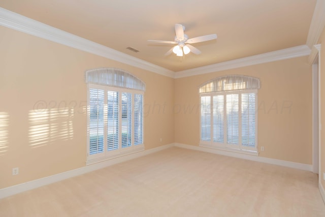 spare room with crown molding, ceiling fan, and light carpet