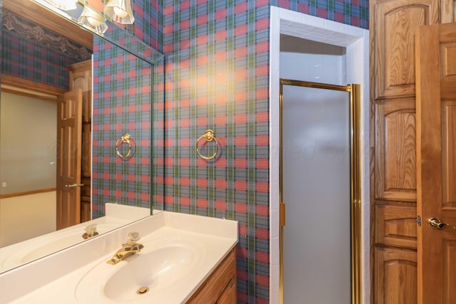 bathroom featuring vanity and an enclosed shower