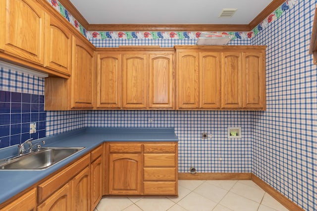 kitchen featuring sink and light tile patterned floors