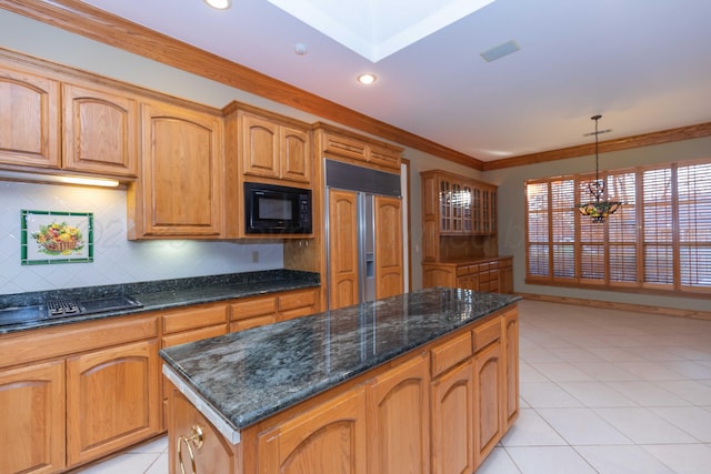 kitchen featuring tasteful backsplash, ornamental molding, a kitchen island, pendant lighting, and black appliances