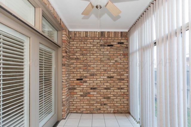 unfurnished sunroom featuring ceiling fan