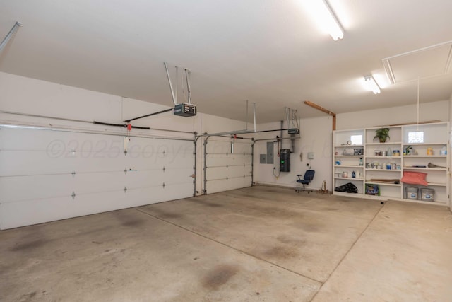 garage with a garage door opener and electric panel