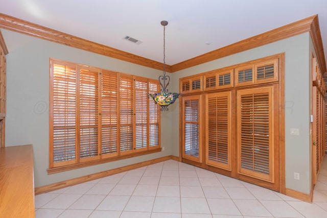 unfurnished dining area featuring ornamental molding and light tile patterned flooring