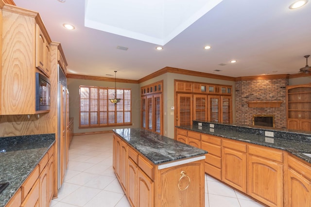 kitchen featuring light tile patterned flooring, black microwave, hanging light fixtures, a center island, and crown molding