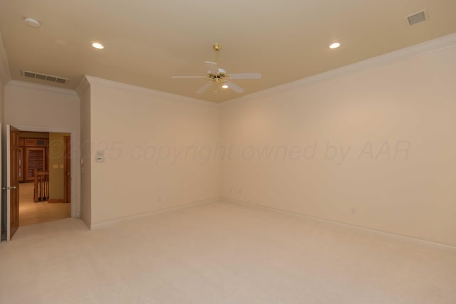 carpeted spare room featuring ornamental molding and ceiling fan